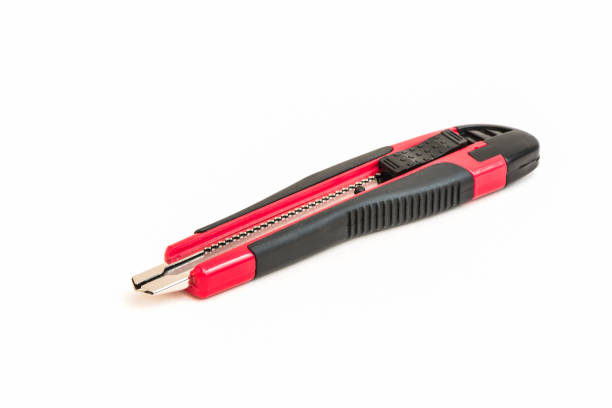 istock Red and black knife cutter isolated on white 866893912