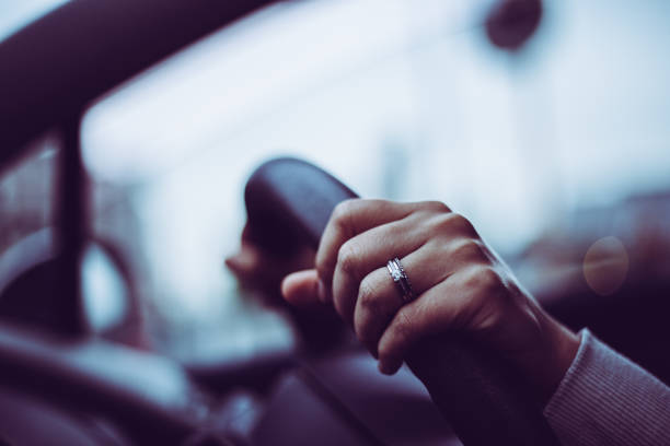 istock Close-up of a woman's hand holding a car handle 866893928