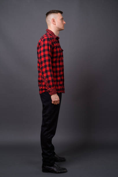 istock Young handsome man wearing red checked shirt against gray background 866894506