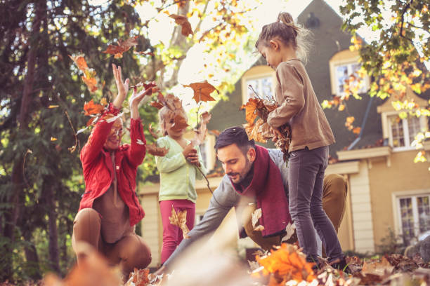 istock Happy family outside in colorful fall backyard. 866894804