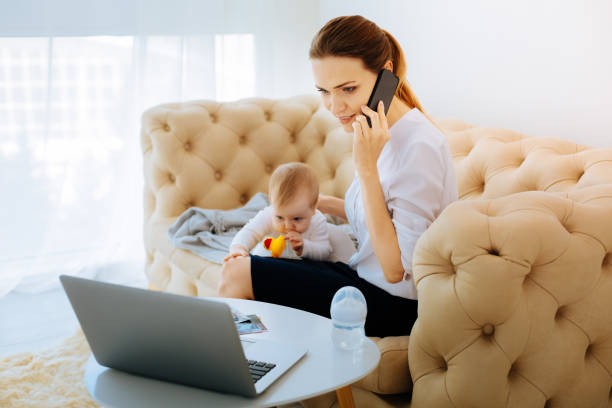 istock Busy working mother talking on the phone 866894888
