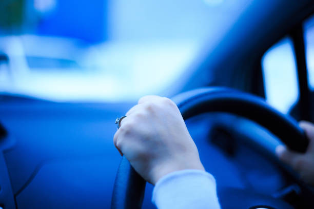 Close-up of a woman's hand holding a car handle