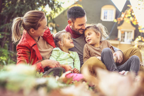 istock Happy family outside in colorful fall backyard. 866897230