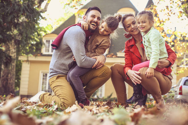 istock Happy family outside in colorful fall backyard poses to camera. 866897232