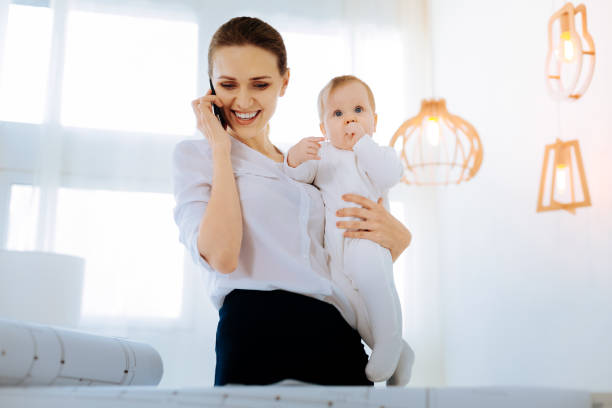 istock Happy young mother hearing pleasant words on the phone 866897384