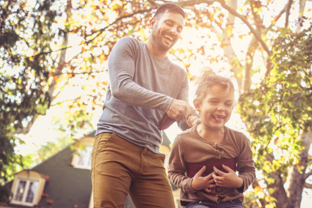 istock Happy family outside in colorful fall backyard. 866898652