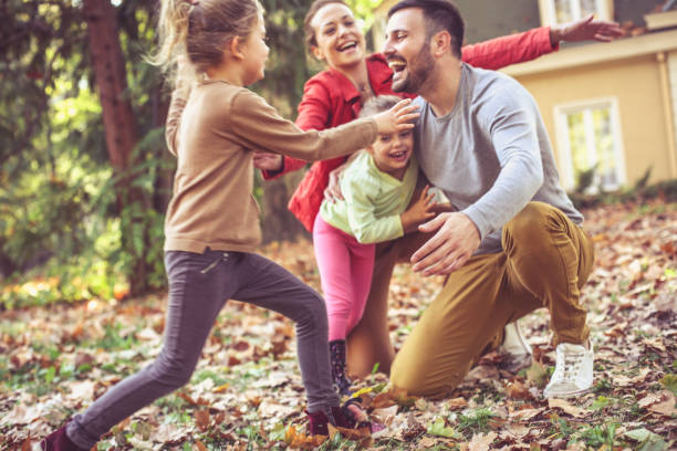 istock Happy smiling family running and playing  at backyard. 866901034