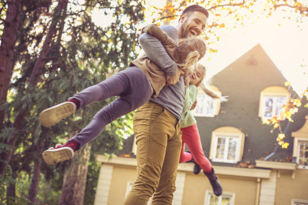 istock Father carrying daughters around neck.  Side view. 866901642