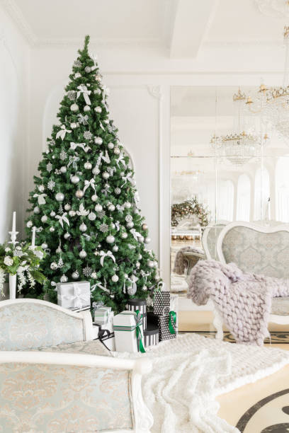 istock Christmas morning. classic apartments with a white fireplace, decorated tree, bright sofa, large windows 866904382