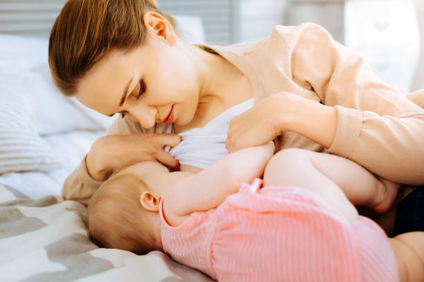 istock Concentrated mother during breastfeeding her baby 866904440