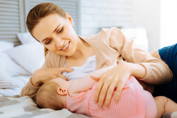 istock Happy calm mother breastfeeding her dear little child 866904532
