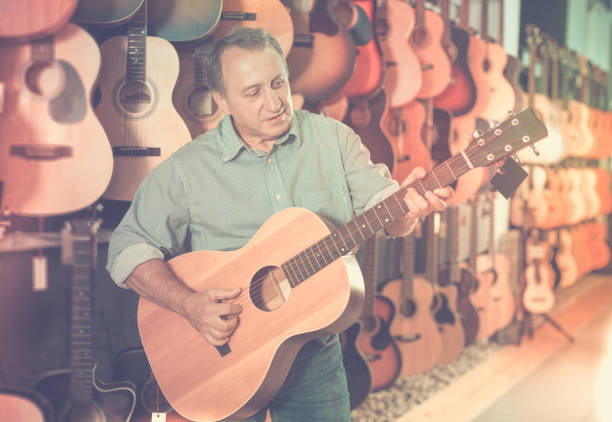 istock Man is playing on acoustic guitar 866904572