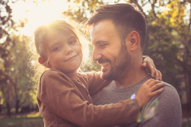 istock Father carrying daughter in arms, poses to camera. 866904768