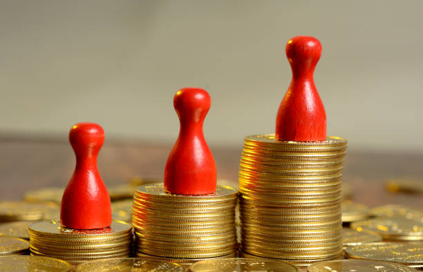istock Stack of Golden Coins Graph going up with pawns 866905054
