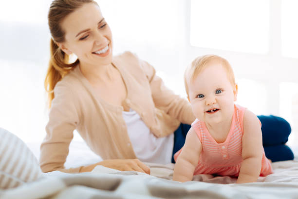 istock Happy little baby learning to crawl 866905074