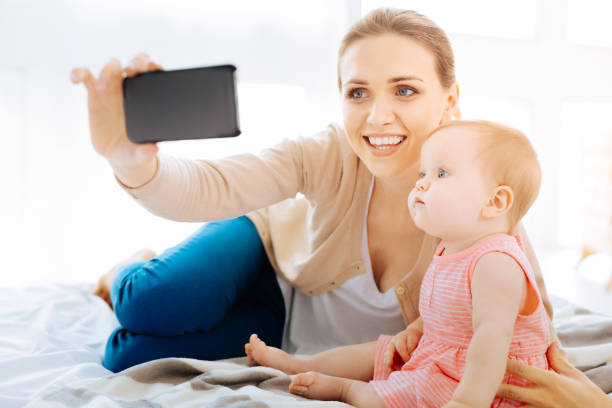istock Delighted woman taking photos with her daughter 866905342