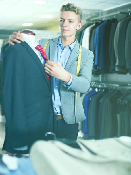 istock Seller in business clothes measuring jacket 866908864