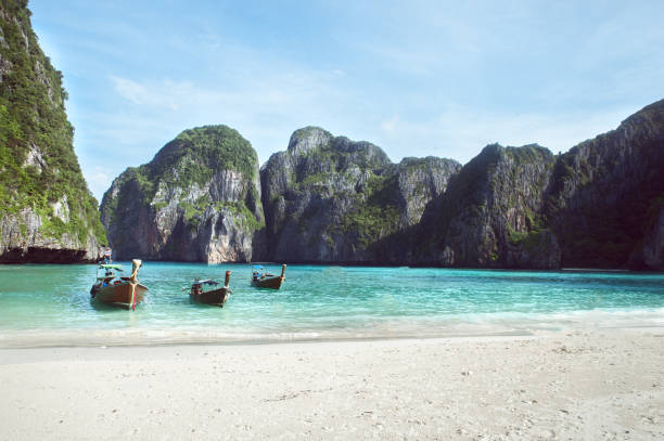 istock Beach with white sand landscape. Boat mooring in Asian style, canoe. Phi Phi Ley Thailand 866910160