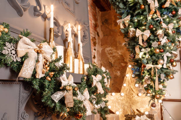 istock Christmas tree branch on fireplace and other holiday decorations in dark loft 866910196