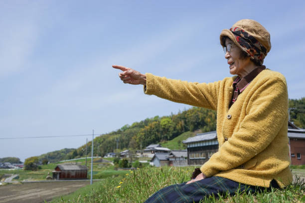 Elderly woman pointing to the sky