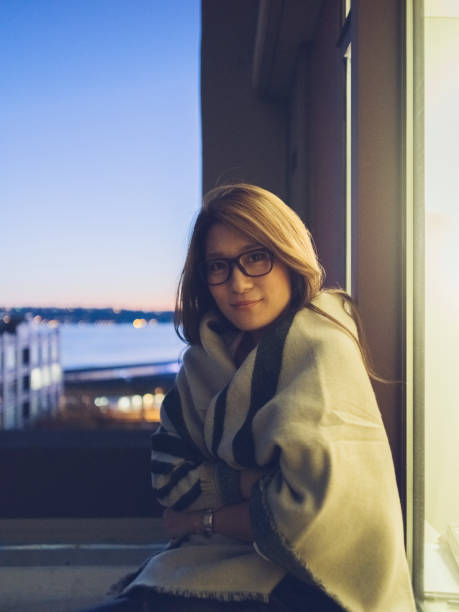 istock young woman wrapped in blanket sitting at night 866913906