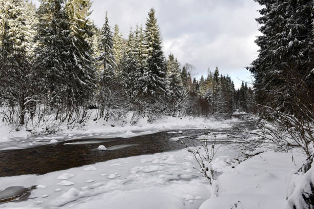 istock Winter landscape of a small snowy river 866917256