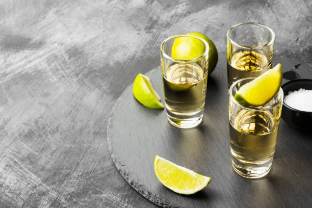 Tequila with lime and salt on a dark background. Copy space. Food background Tequila with lime and salt on a dark background. Copy space. Food background tequila shot stock pictures, royalty-free photos & images