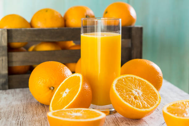 Glass of orange juice Glass of orange juice with oranges freshly squeezed stock pictures, royalty-free photos & images