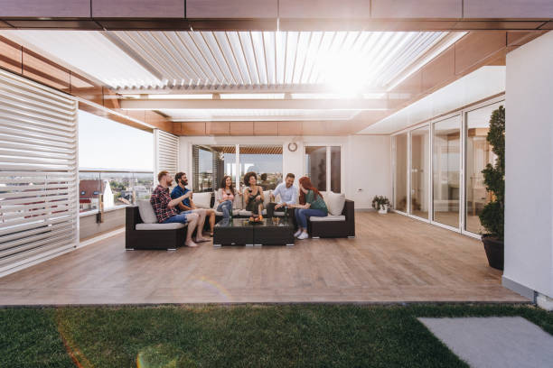 istock Young happy people enjoying in drinks while talking on a penthouse patio. 866922004
