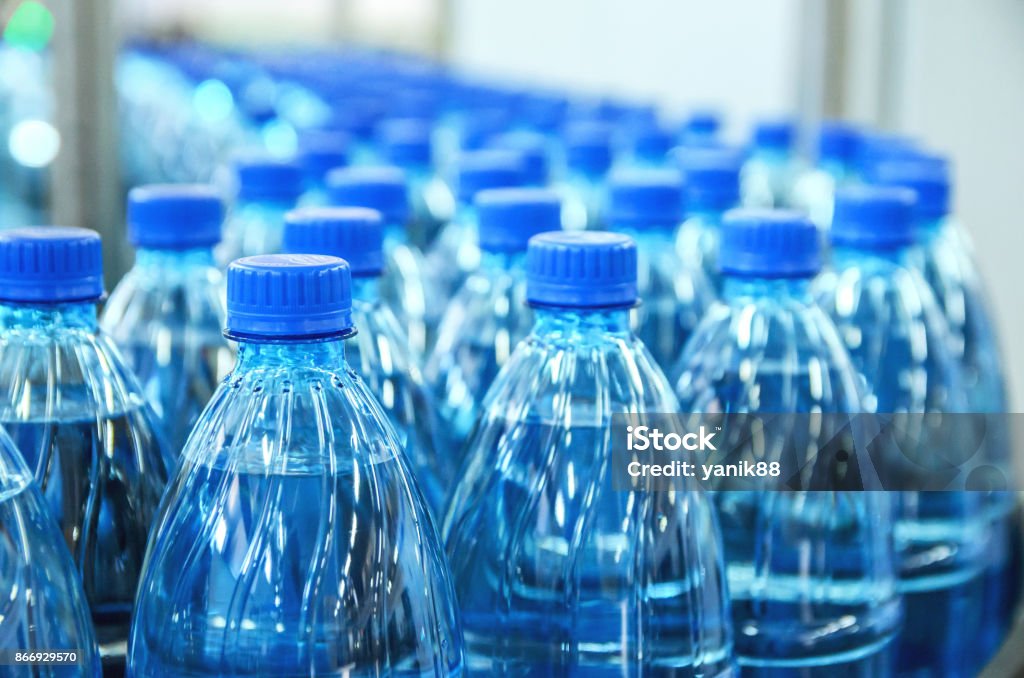 Closeup on mineral water bottles in raw and lines Closeup on mineral water green bottles in raw and lines Water Bottle Stock Photo