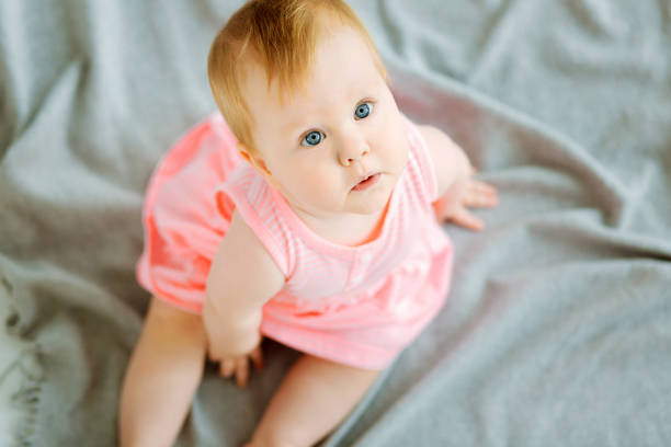 istock Adorable little girl looking up high 866929754