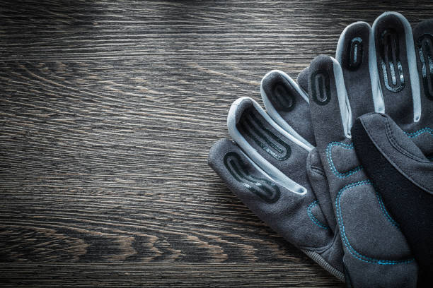 istock Pair of protective gloves on wooden board 866929766