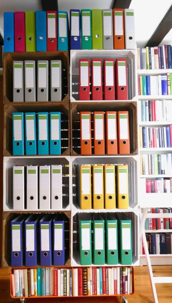 istock Colorful ring binders in front of book shelves 866939680