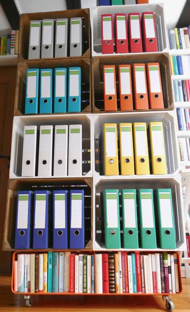 istock Colorful ring binders in front of book shelves 866939742