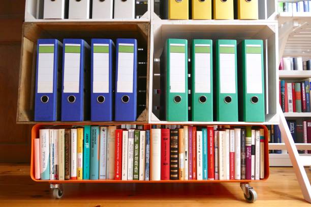 istock Colorful ring binders in front of book shelves 866939794