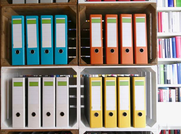 istock Colorful ring binders in front of book shelves 866940166