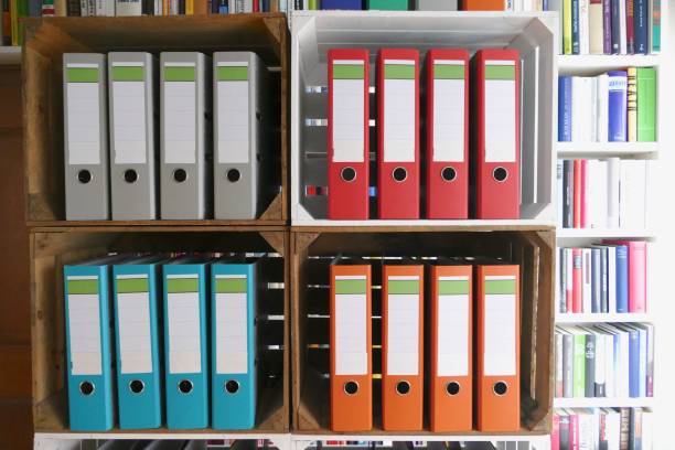 istock Colorful ring binders in front of book shelves 866940196