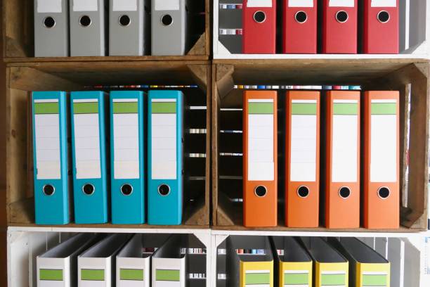 istock Colorful ring binders in wooden boxes shelves 866940276