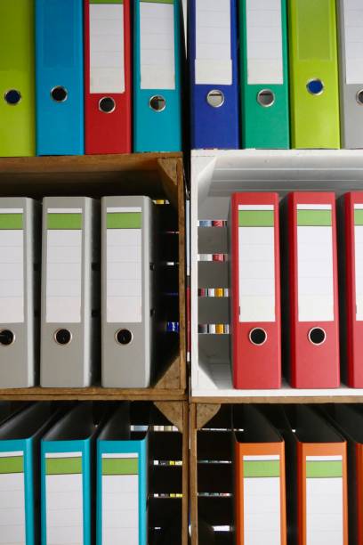 istock Colorful ring binders in wooden boxes shelves 866940314