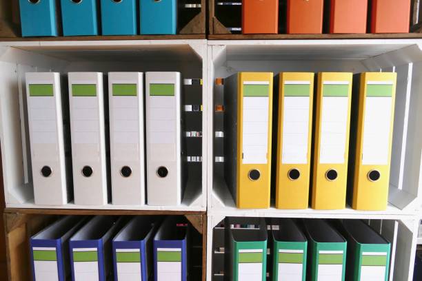 istock Colorful ring binders in wooden boxes shelves 866940338
