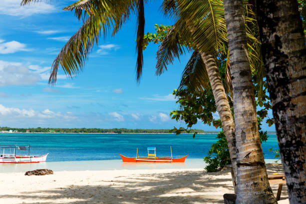 tropical guyam island with traditional fishing boats, philippines - nautical vessel philippines mindanao palawan imagens e fotografias de stock