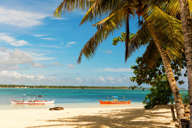 tropical guyam island with traditional fishing boats, philippines - nautical vessel philippines mindanao palawan imagens e fotografias de stock