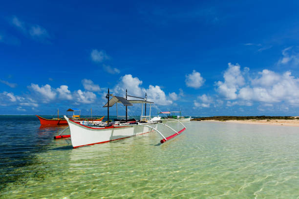 Traditional fishing boat on pristine beach, Philippines
