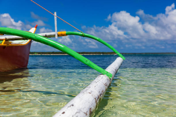 Traditional fishing boat on pristine beach, Philippines