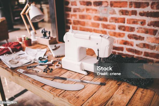 Desk Of Fashion Designer With Sewing Machine And Tools Stock Photo - Download Image Now