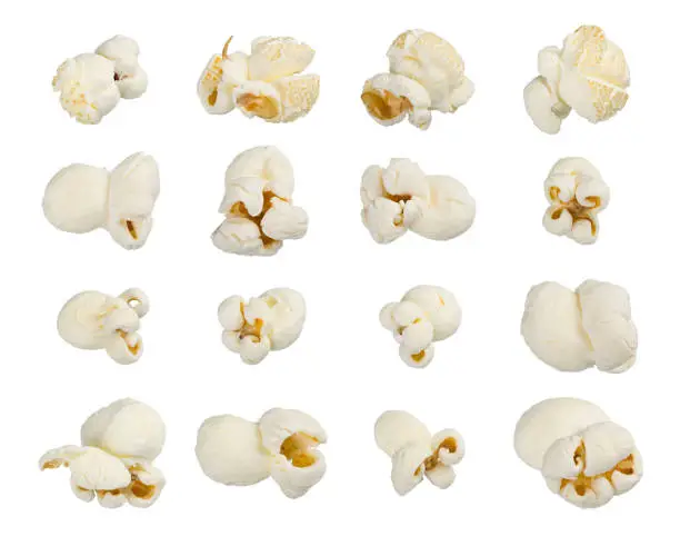 Scattered popcorn isolated on white background. Close up shot. High quality image. astfood popular during a movie in a cinema. Desogn element for advertisement, flyer, poster.