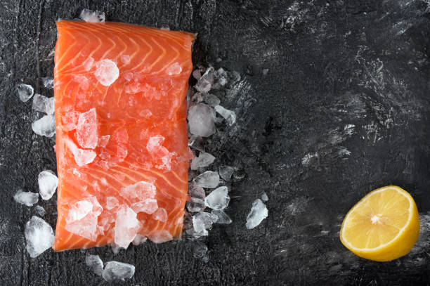 istock Fresh salmon fillet and lemon. Top view. 866951348