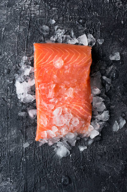 Fresh salmon fillet. Vertical photo. stock photo