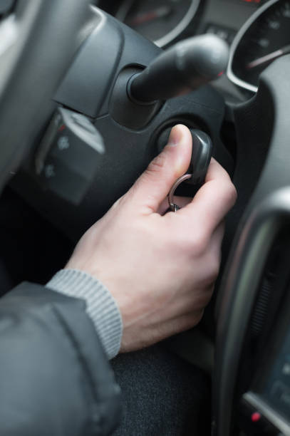 istock Closeup inside vehicle of hand holding key in ignition, start engine key 866954288