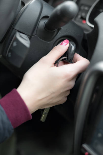 istock Closeup inside vehicle of hand holding key in ignition, start engine key 866954460